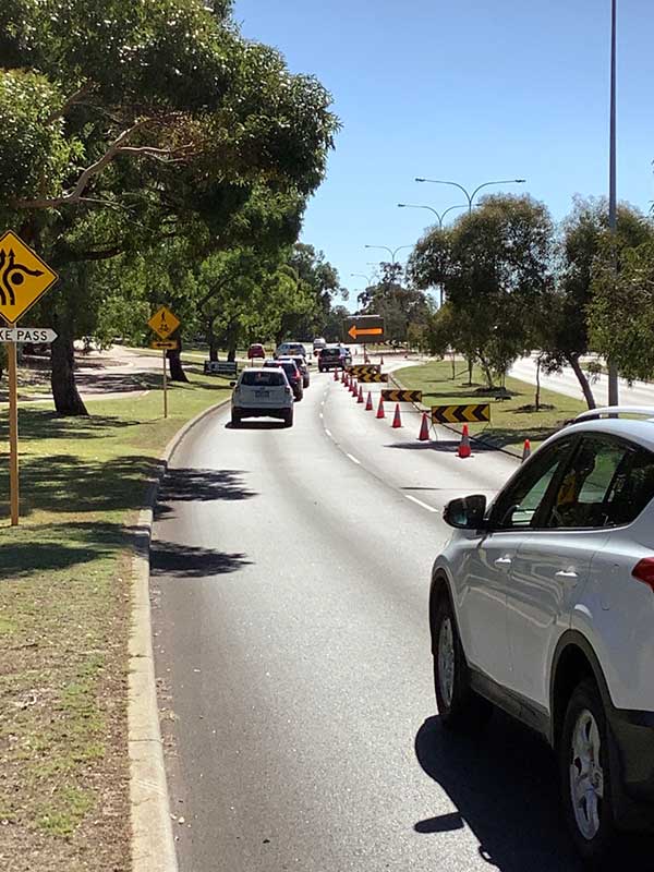 Cars being diverted on road by traffic management